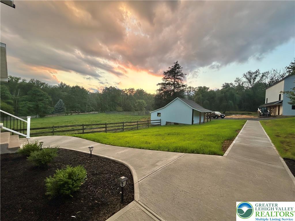 72 Allegheny Road Mount Bethel, PA 18343 - Photo 4 of 72 Rural charm abounds with expansive green pastures and a classic white barn at sunset.