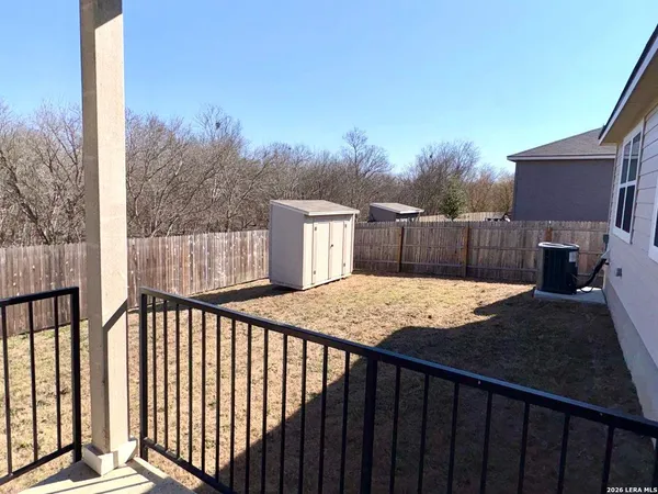 a view of a roof deck with wooden fence and floor