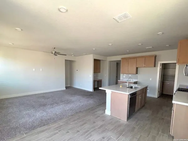 a kitchen with stainless steel appliances a sink a stove a refrigerator and cabinets