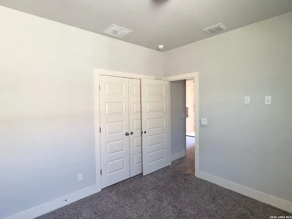 an empty room with closet area