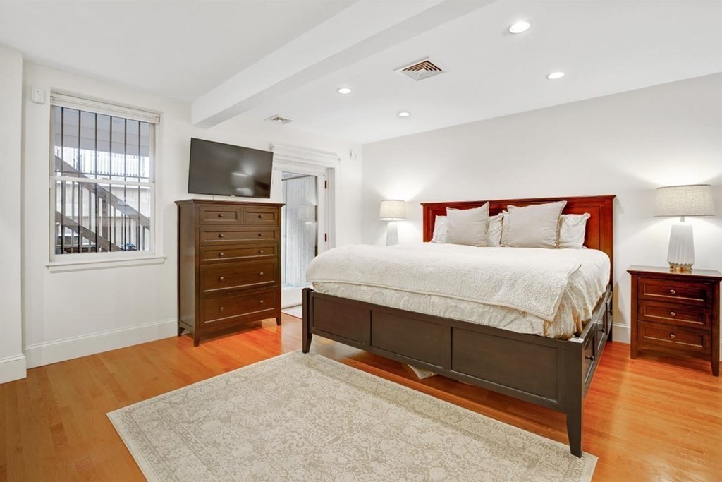 5 Bond Street, Unit 1 Boston, MA 02118 - Photo 13 of 18 a bedroom with a bed and a flat screen tv