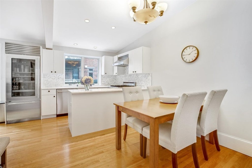 5 Bond Street, Unit 1 Boston, MA 02118 - Photo 3 of 18 a kitchen with a table chairs and a refrigerator
