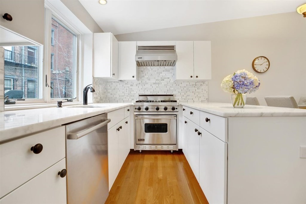 5 Bond Street, Unit 1 Boston, MA 02118 - Photo 4 of 18 a kitchen with a sink stove and cabinets