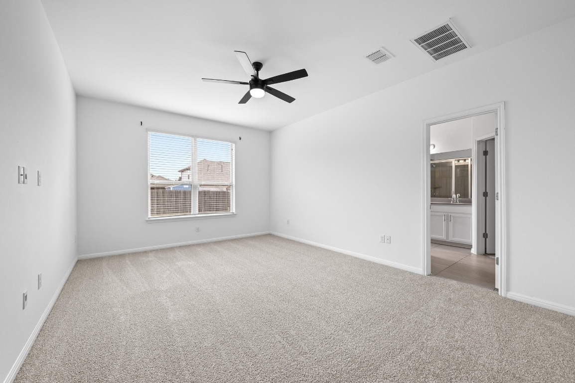 13221 Mariscan Street Manchaca, TX 78652 - Photo 16 of 36 Empty room featuring light colored carpet and ceiling fan