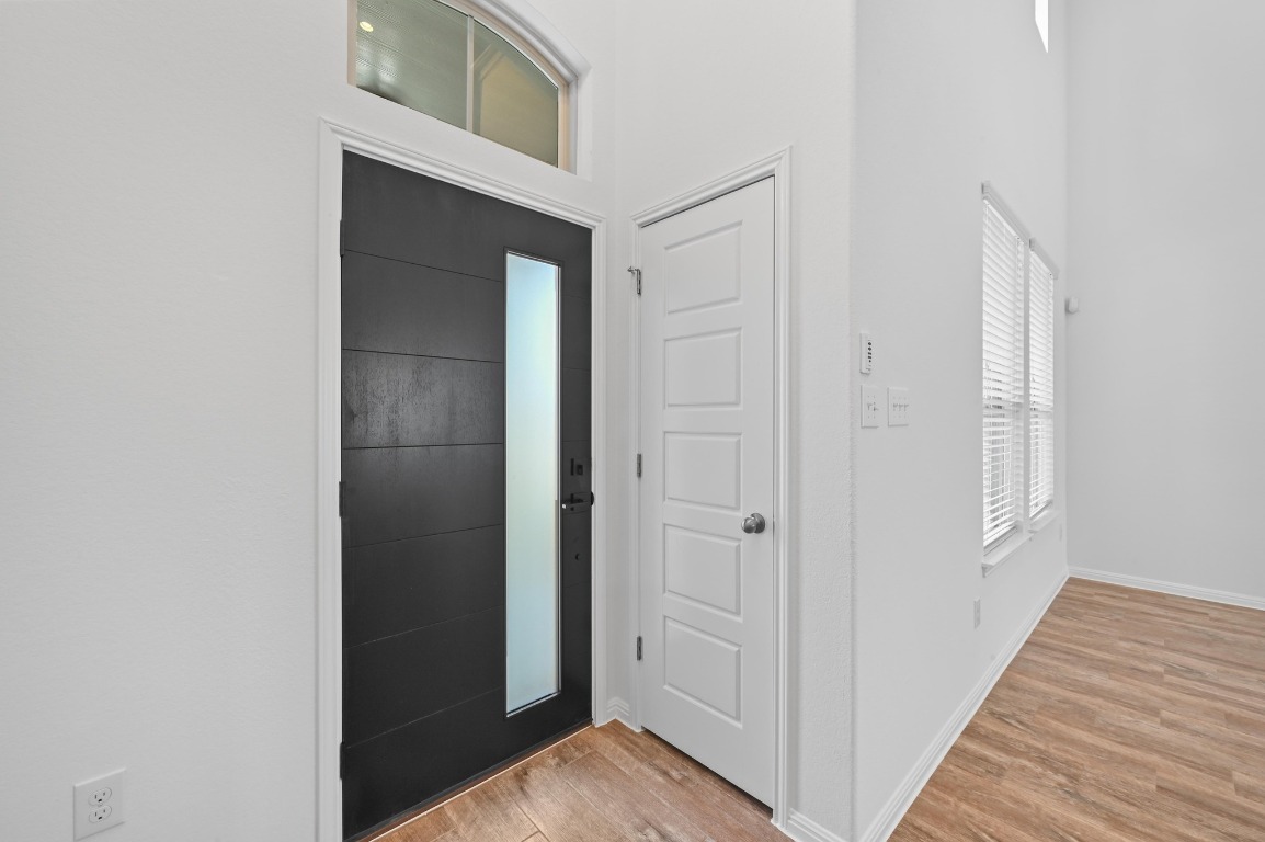 13221 Mariscan Street Manchaca, TX 78652 - Photo 7 of 36 Entrance foyer with light wood finished floors and a high ceiling