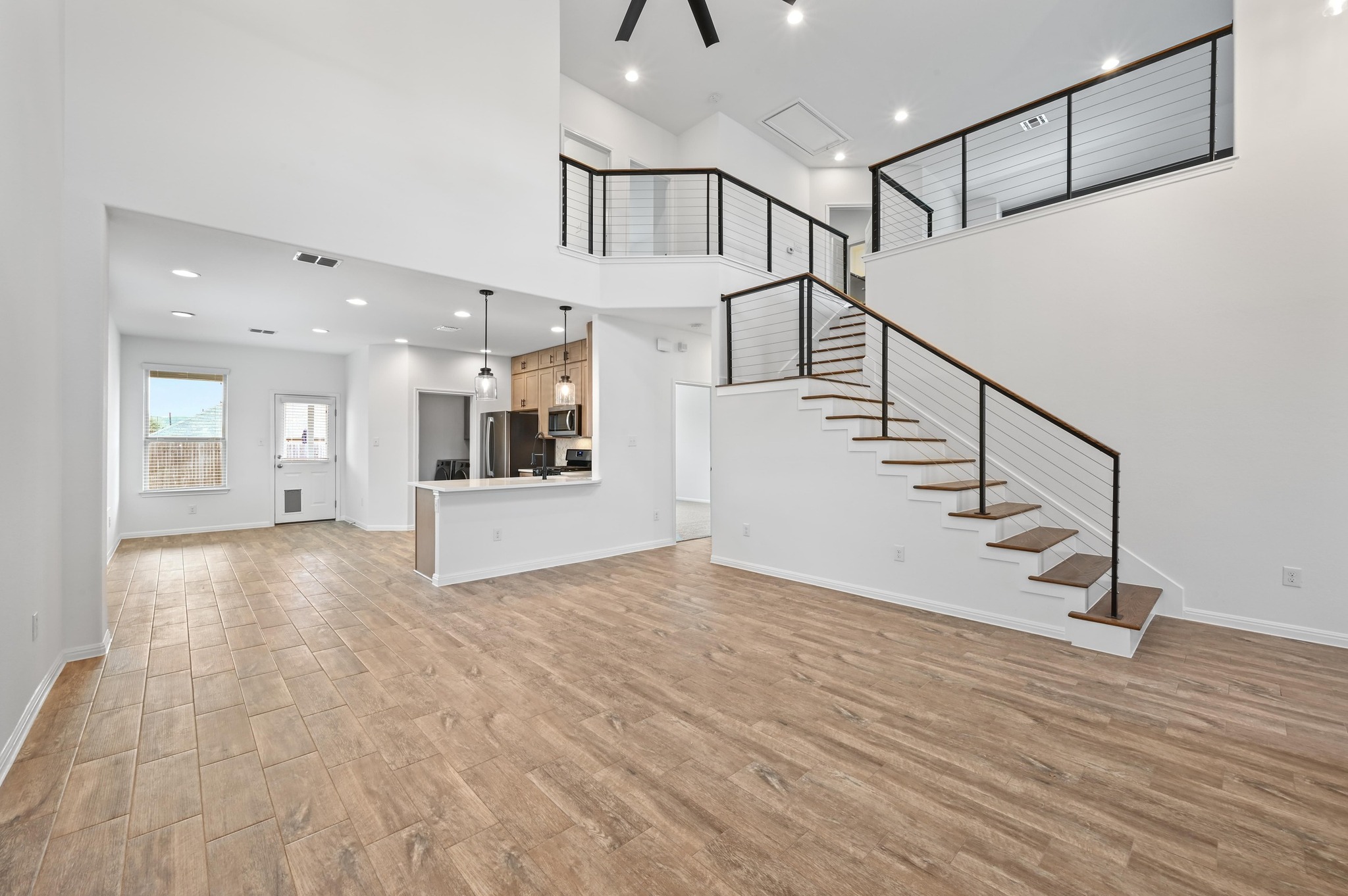 13221 Mariscan Street Manchaca, TX 78652 - Photo 10 of 36 a view of a hallway with wooden floor and staircase