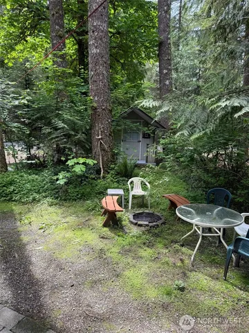 a view of a backyard with table and chairs and couches