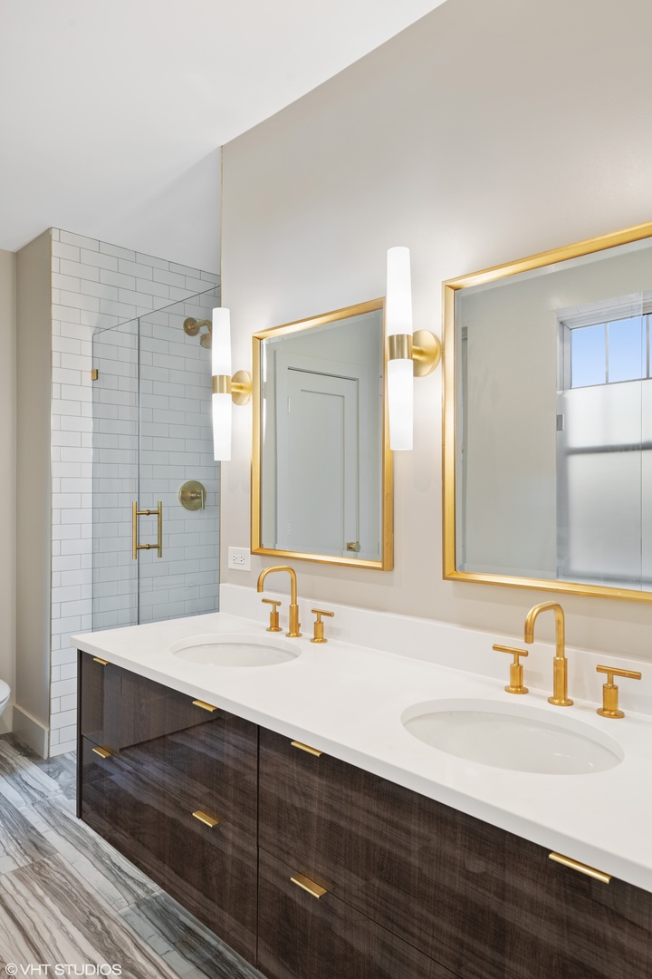 Undisclosed Address Chicago, IL 60657 - Photo 17 of 17 a bathroom with double vanity sinks and a mirror