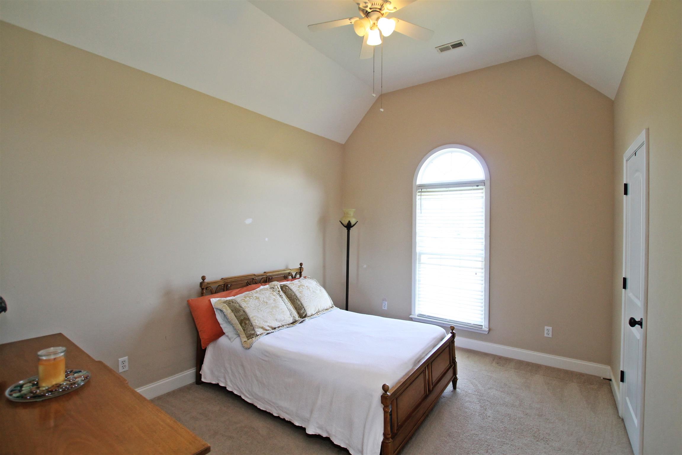 1012 Loganview Way Springfield, TN 37172 - Photo 17 of 30 a bedroom with a bed and a chandelier