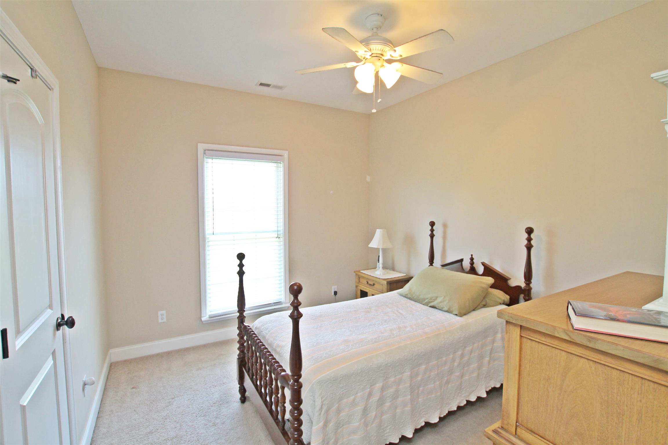 1012 Loganview Way Springfield, TN 37172 - Photo 19 of 30 a bedroom with a bed and a chandelier