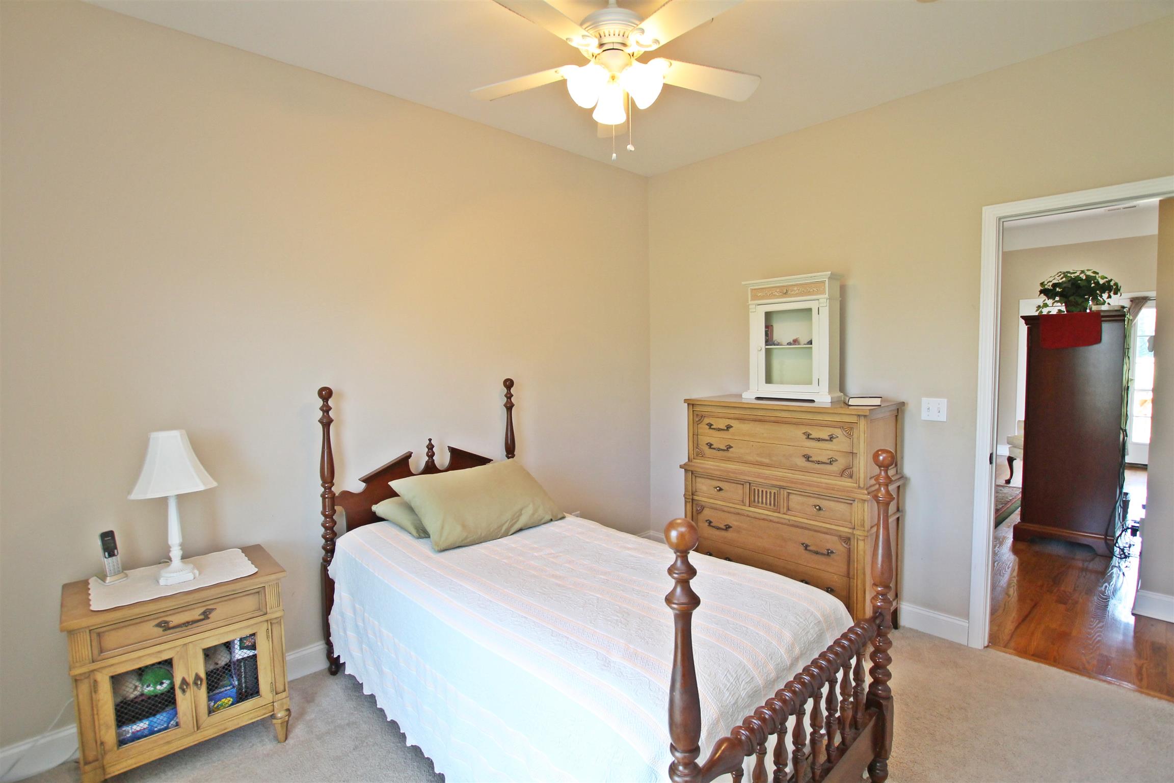 1012 Loganview Way Springfield, TN 37172 - Photo 20 of 30 a bedroom with a bed and wooden floor