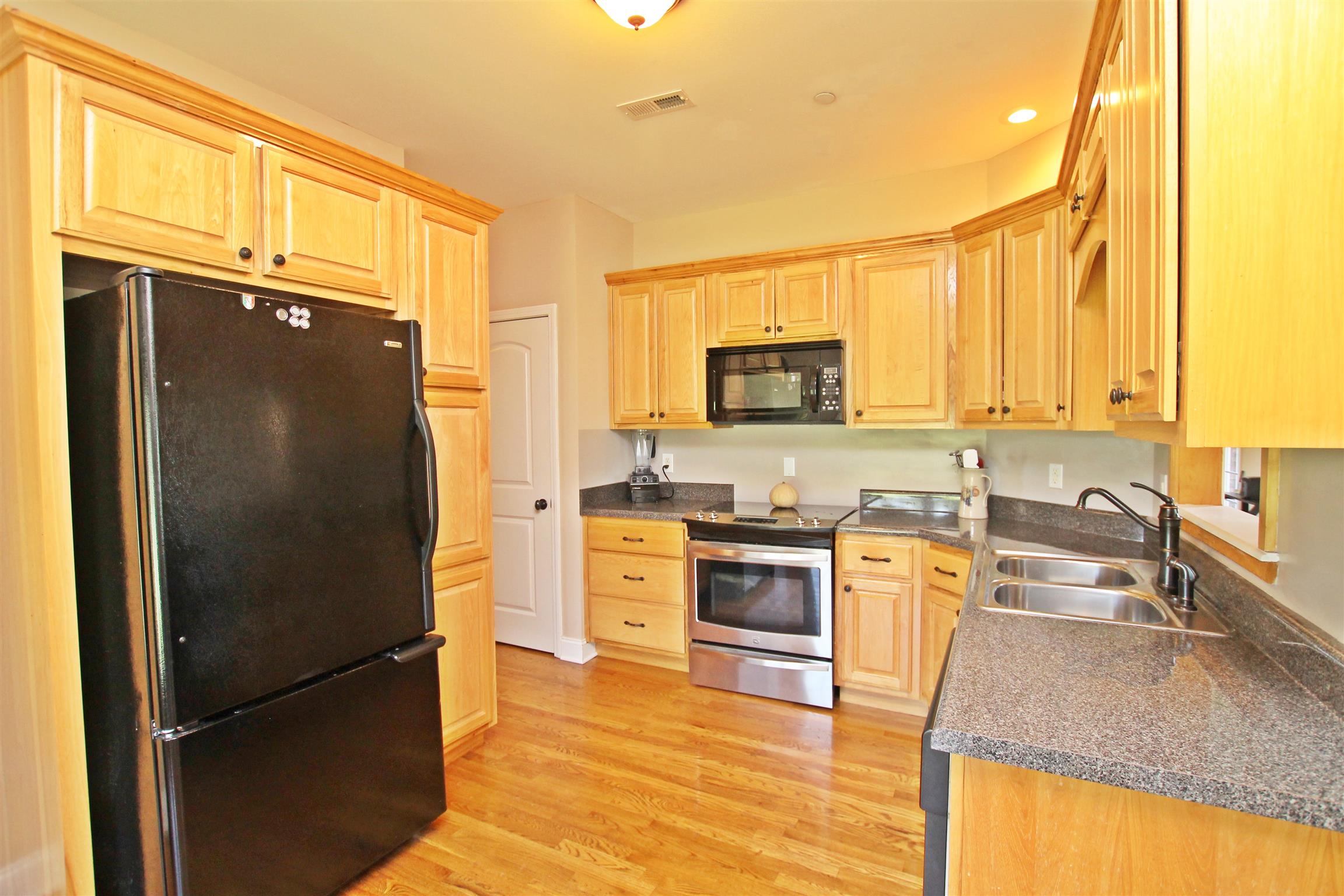 1012 Loganview Way Springfield, TN 37172 - Photo 7 of 30 a kitchen with granite countertop a refrigerator stove top oven and sink