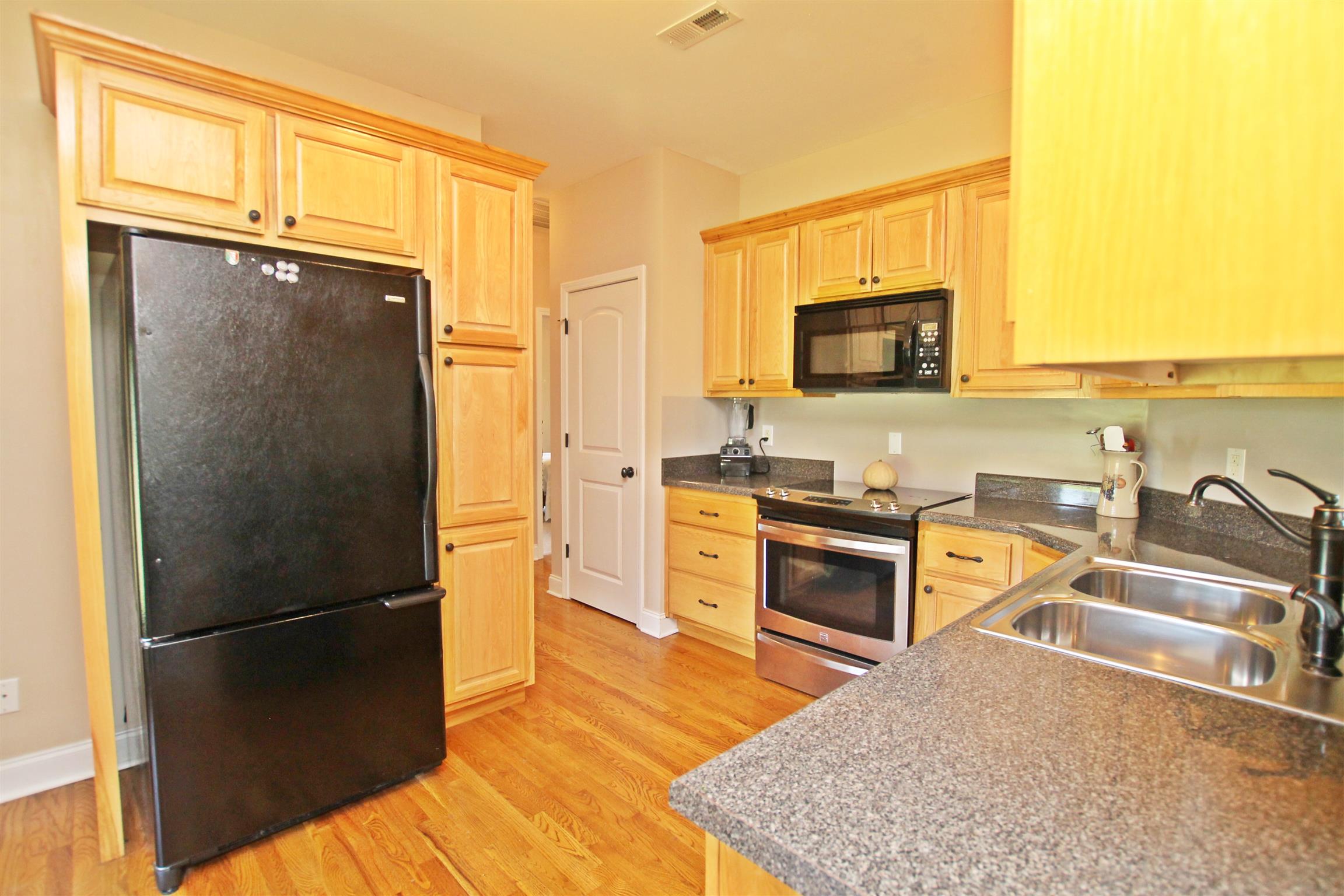 1012 Loganview Way Springfield, TN 37172 - Photo 8 of 30 a kitchen with stainless steel appliances granite countertop a refrigerator stove top oven and a sink with dishwasher