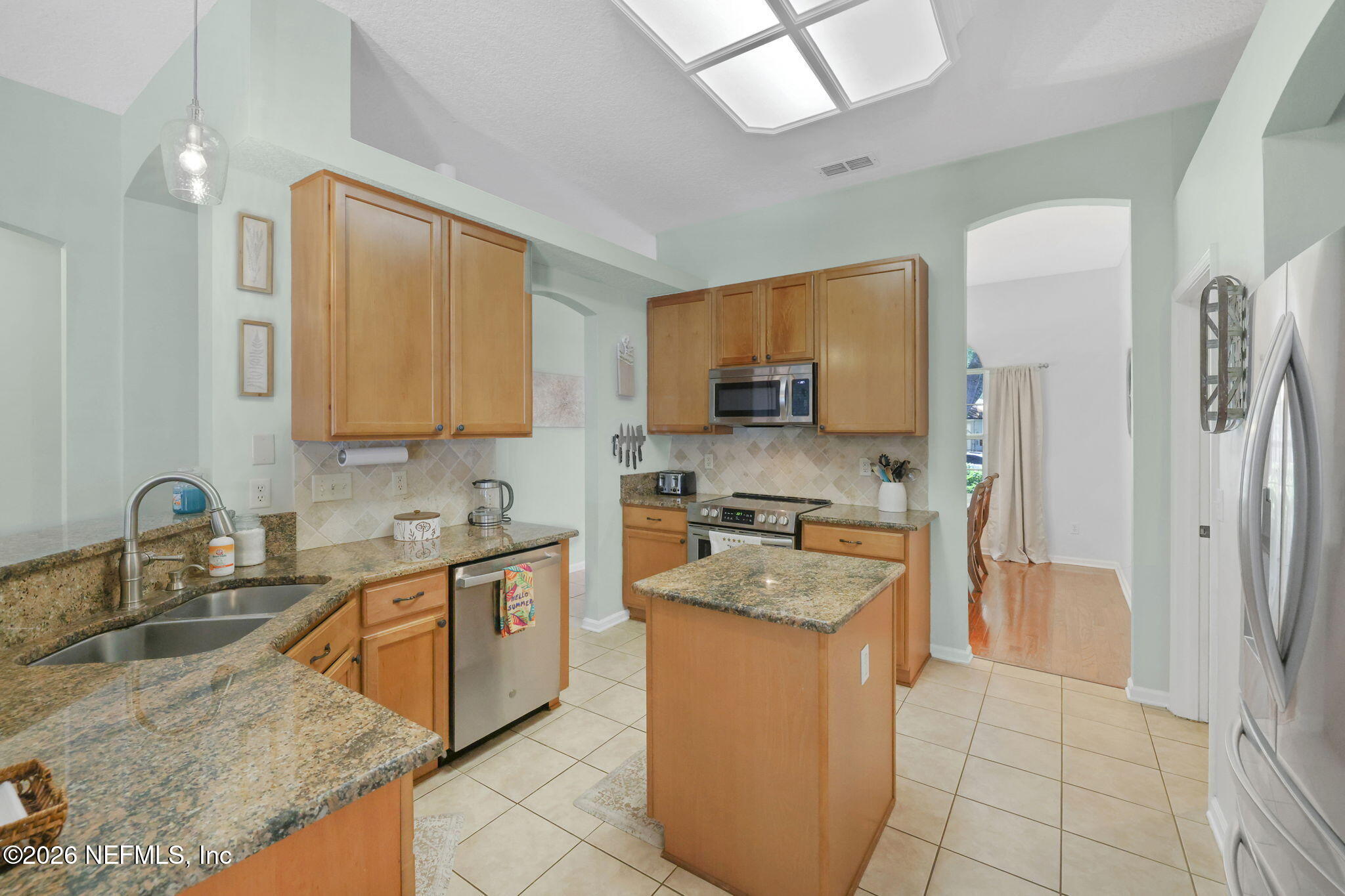 4320 Rye Court St. Johns, FL 32259 - Photo 21 of 60 a kitchen with stainless steel appliances granite countertop a sink stove refrigerator and cabinets