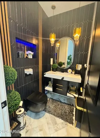 a living room with furniture floor to ceiling window and a flat screen tv