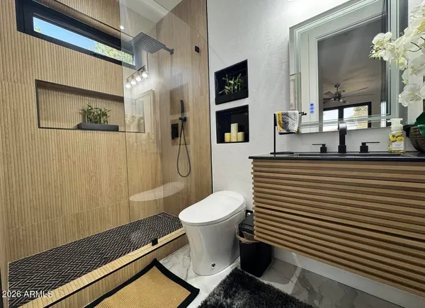 a living room with furniture a flat screen tv and a large window