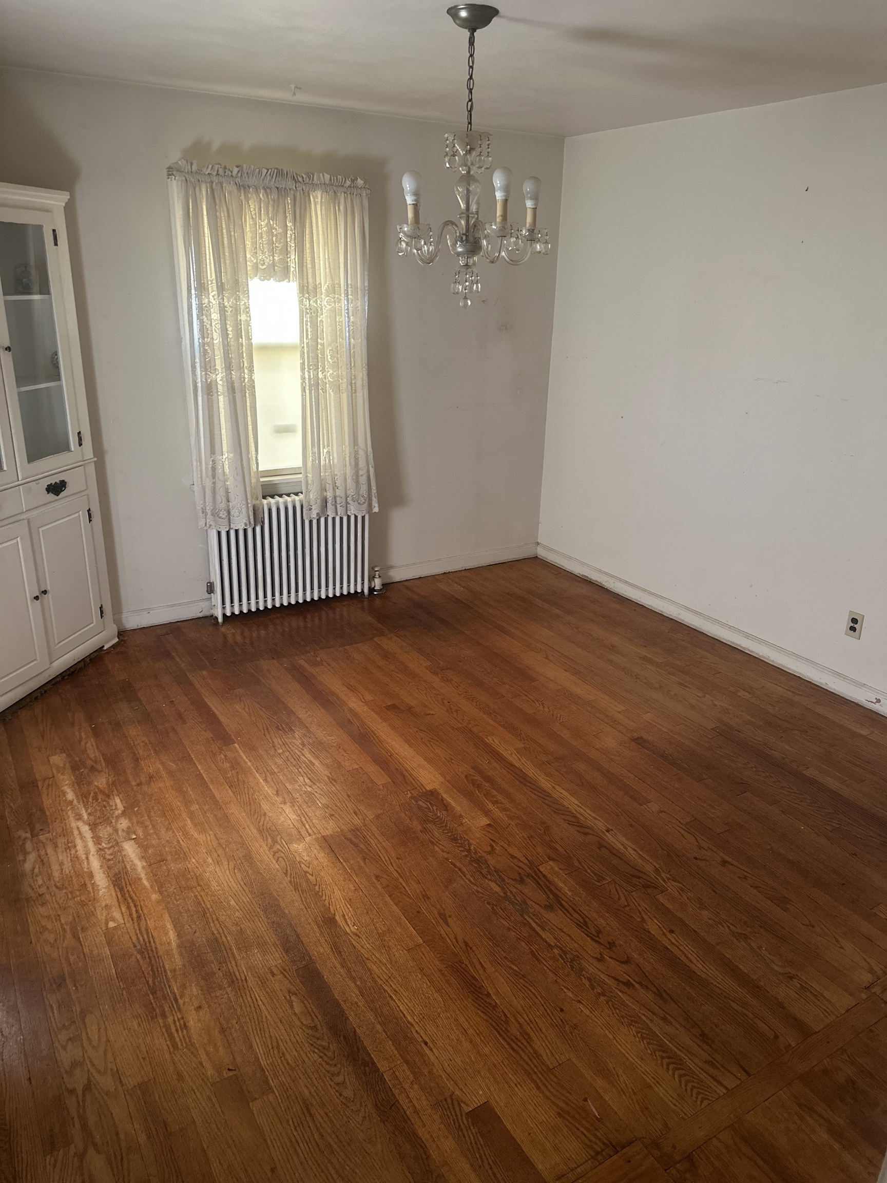 151 Warner Street Hamden, CT 06514 - Photo 3 of 7 an empty room with wooden floor and windows