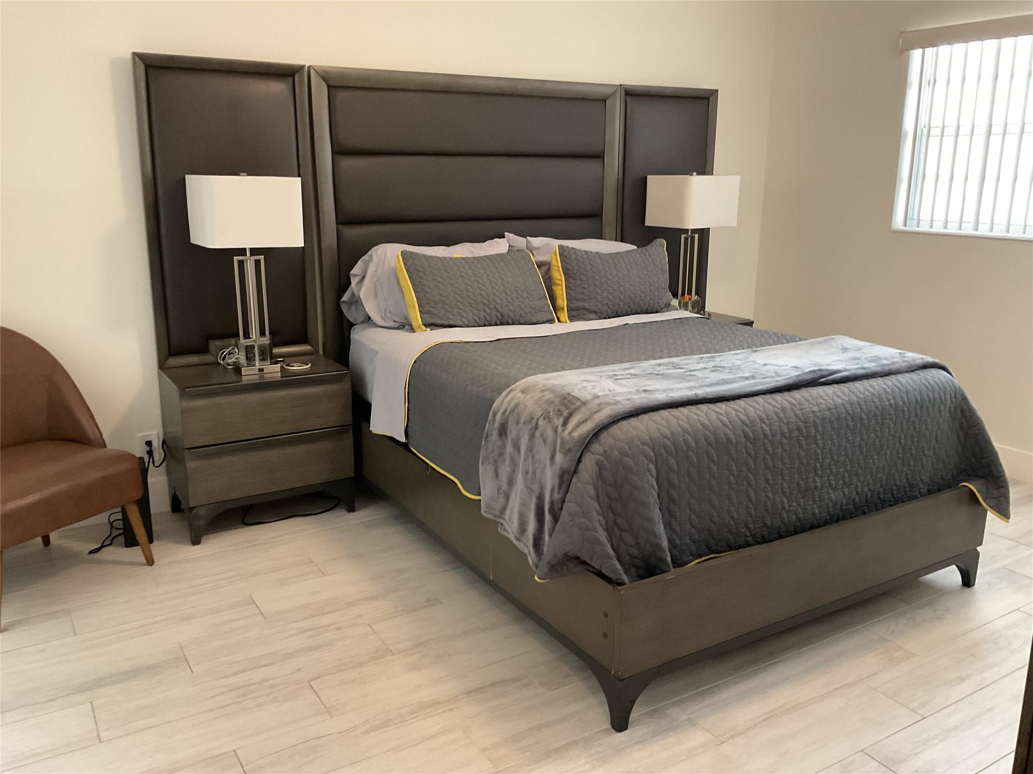 Undisclosed Address Boca Raton, FL 33487 - Photo 4 of 8 a bedroom with a bed and a lamp