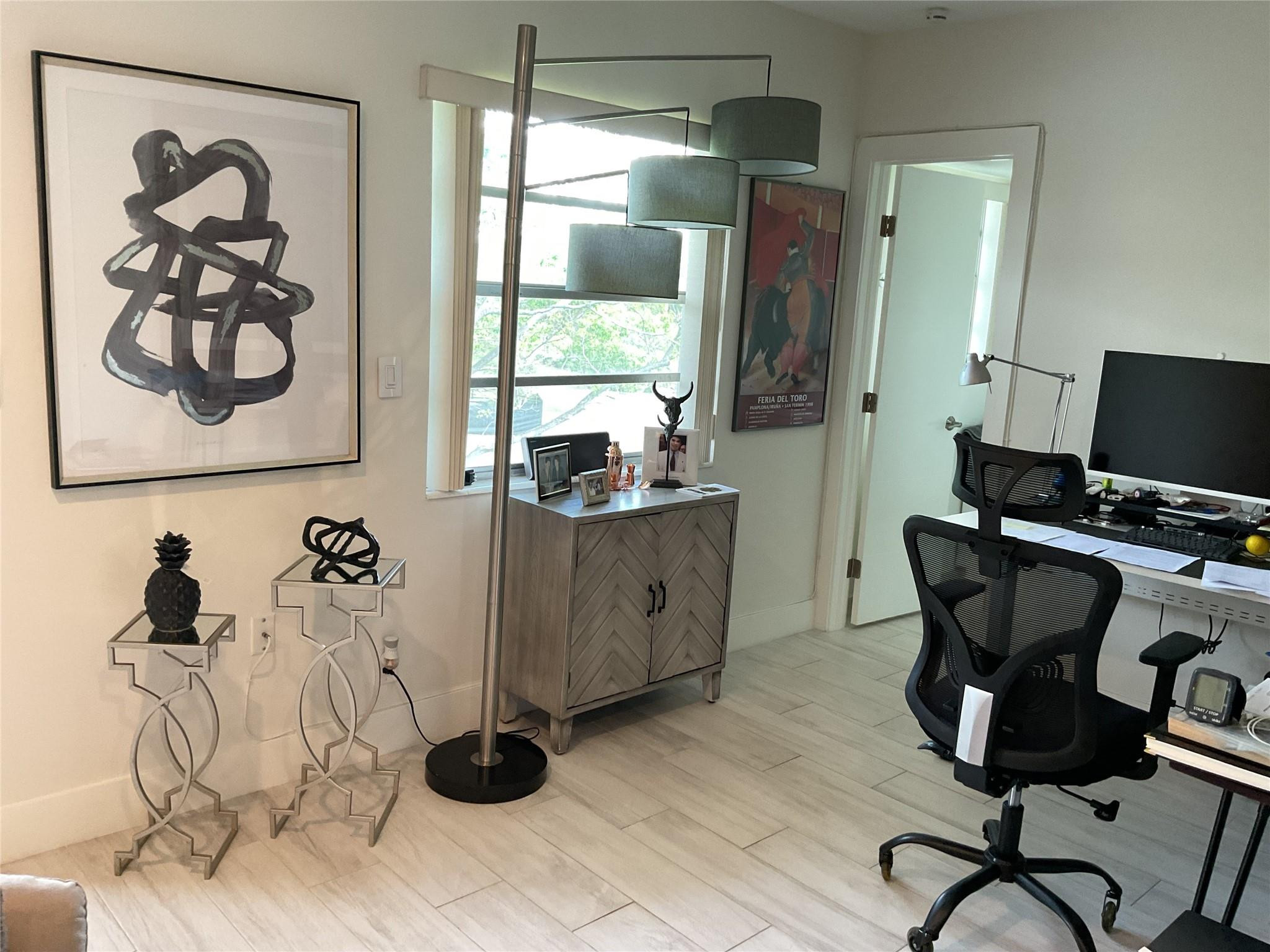 Undisclosed Address Boca Raton, FL 33487 - Photo 5 of 8 a view of a workspace with furniture and a window