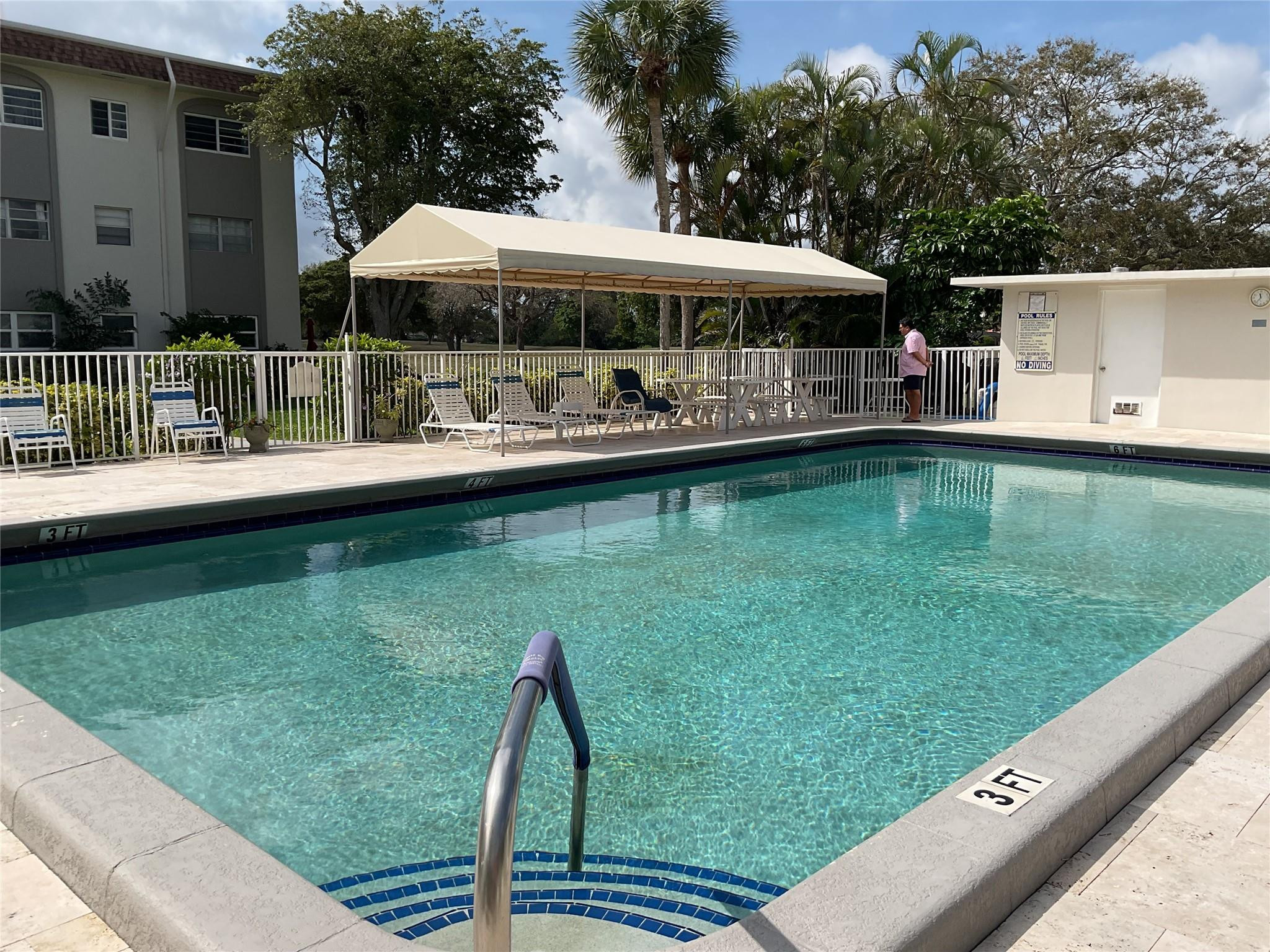 Undisclosed Address Boca Raton, FL 33487 - Photo 7 of 8 a view of swimming pool with lawn chairs and plants