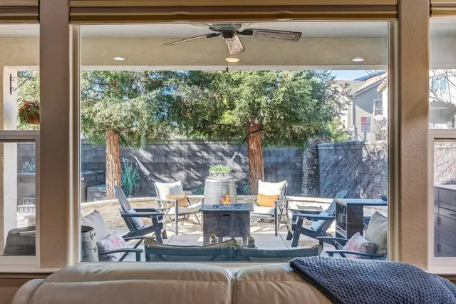 a kitchen with stainless steel appliances granite countertop a table chairs stove and refrigerator