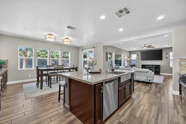 a kitchen with granite countertop stainless steel appliances and wooden cabinets