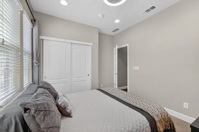 a spacious bathroom with a tub double sink window and mirror
