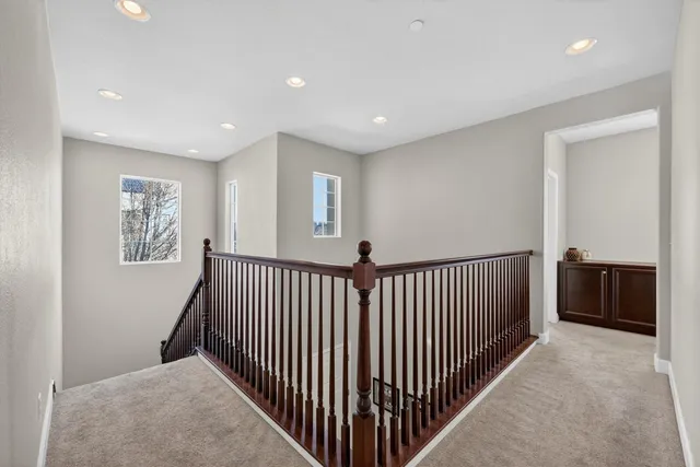 a view of a patio with chairs and potted plants
