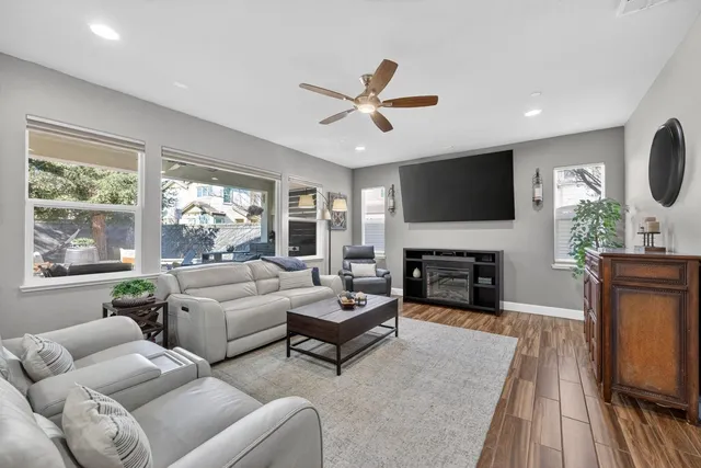 a living room with furniture a fireplace and a flat screen tv