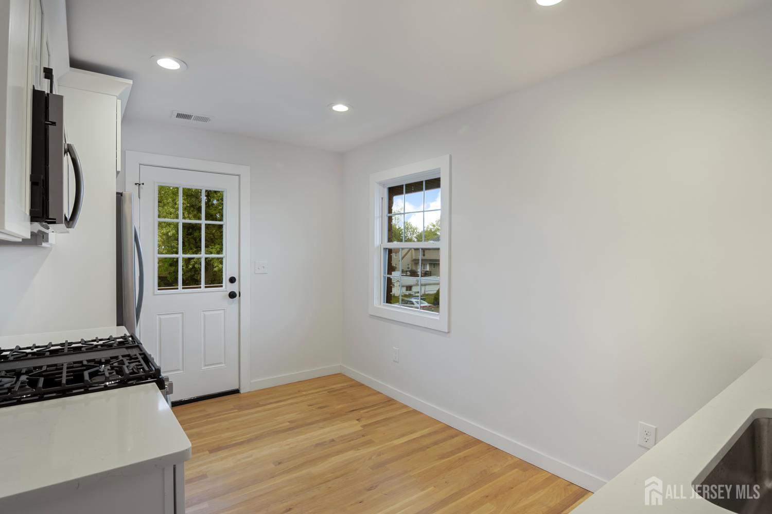 4 Morris Avenue, Unit 2A Edison, NJ 08837 - Photo 7 of 27 a view of a kitchen with a sink wooden floor and a window