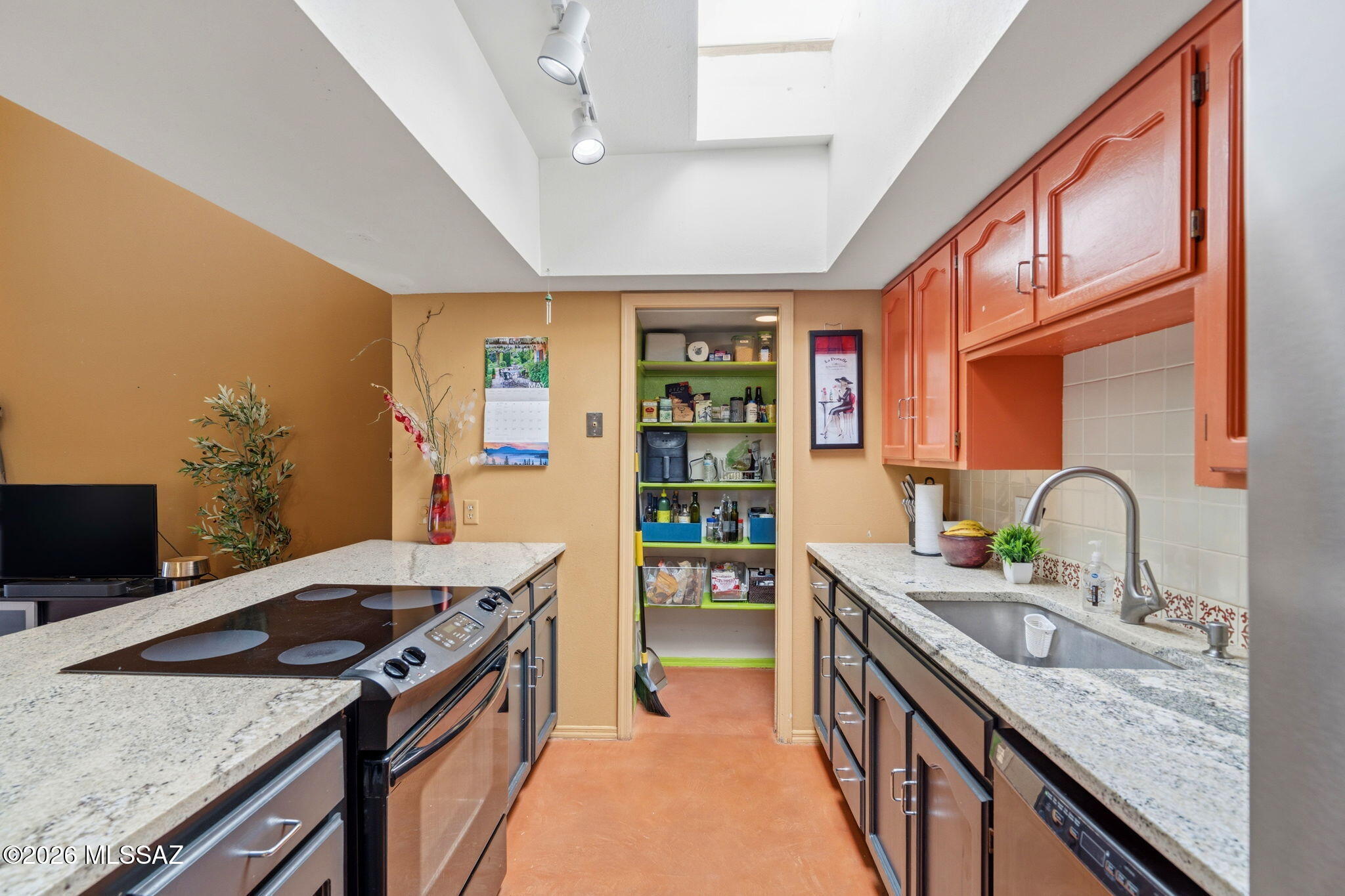 1200 East River Road, Unit G87 Tucson, AZ 85718 - Photo 11 of 30 a kitchen with stainless steel appliances granite countertop a sink and a stove