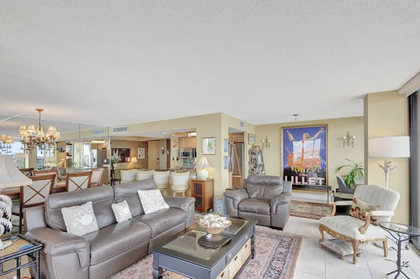 a living room with furniture and a floor to ceiling window