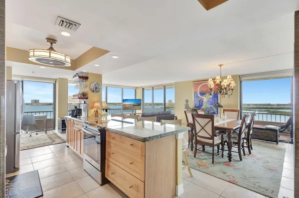 a view of a dining room with furniture a chandelier and wooden floor