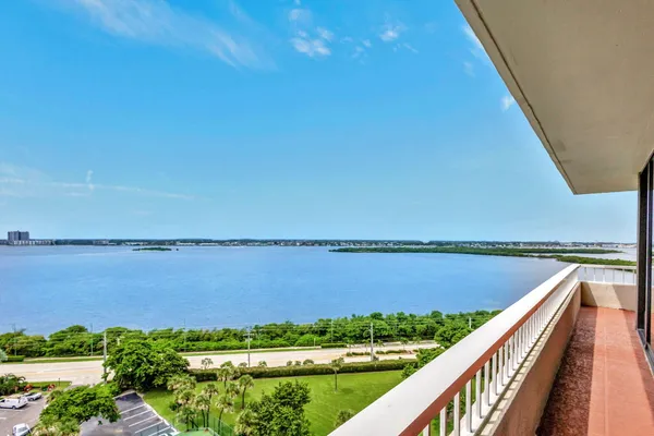 a living room with furniture and view of kitchen