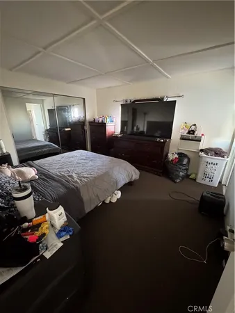 a bedroom with bed and dresser
