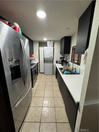 a kitchen with stainless steel appliances a refrigerator and a counter top space