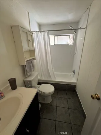 a bathroom with a toilet a sink and a shower