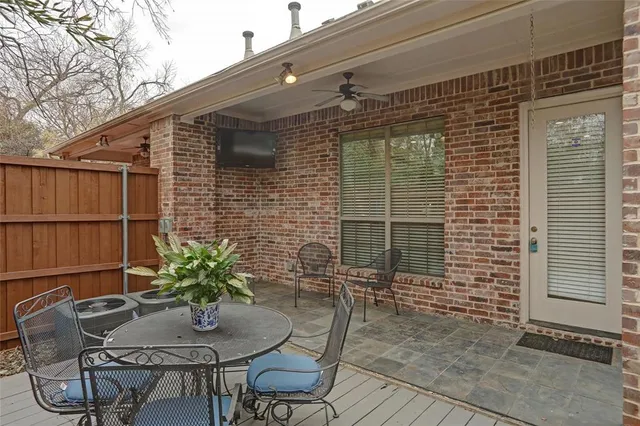 a backyard of a house with table and chairs
