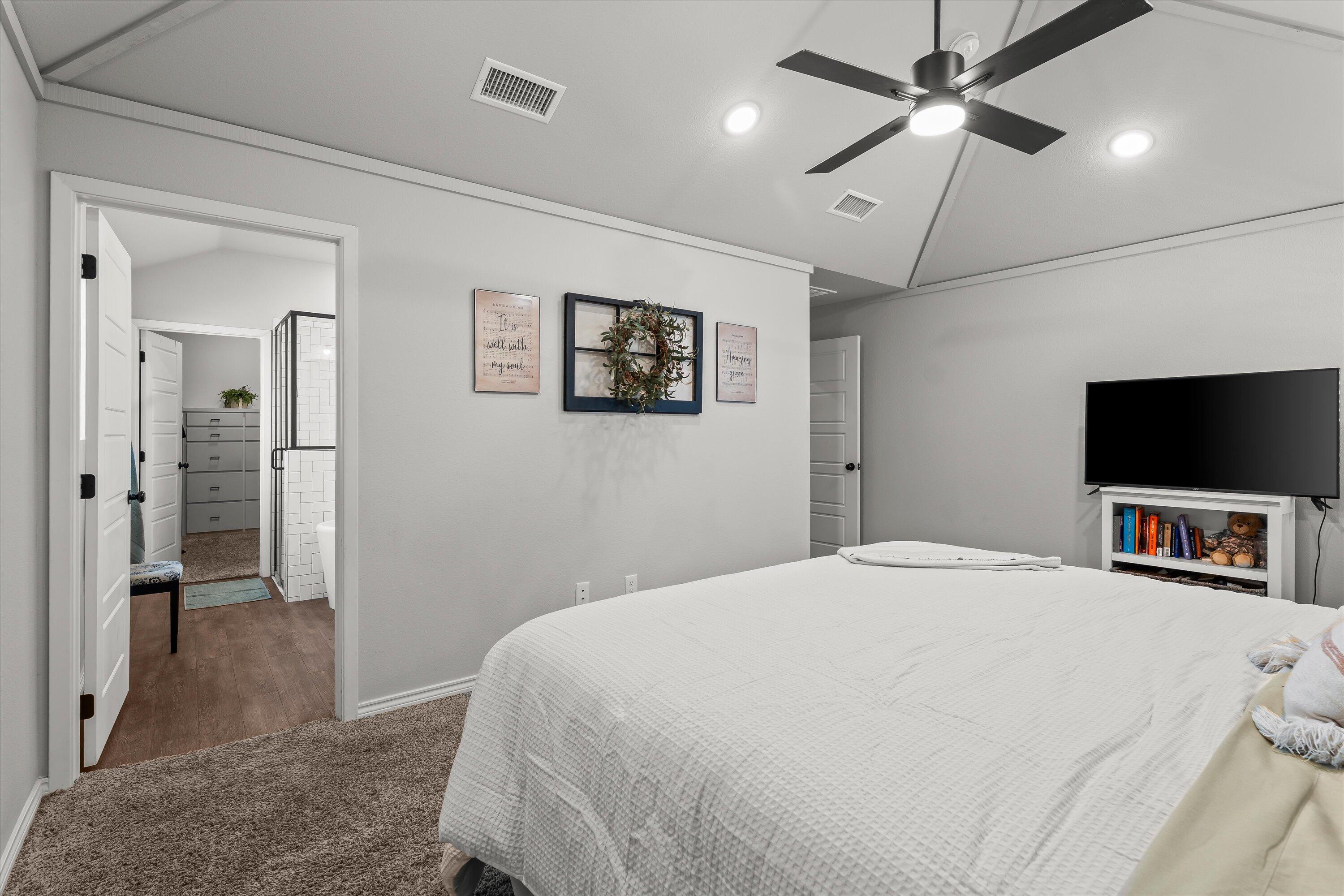 3438 125th Street Lubbock, TX 79423 - Photo 16 of 34 a bedroom with a bed and a flat screen tv