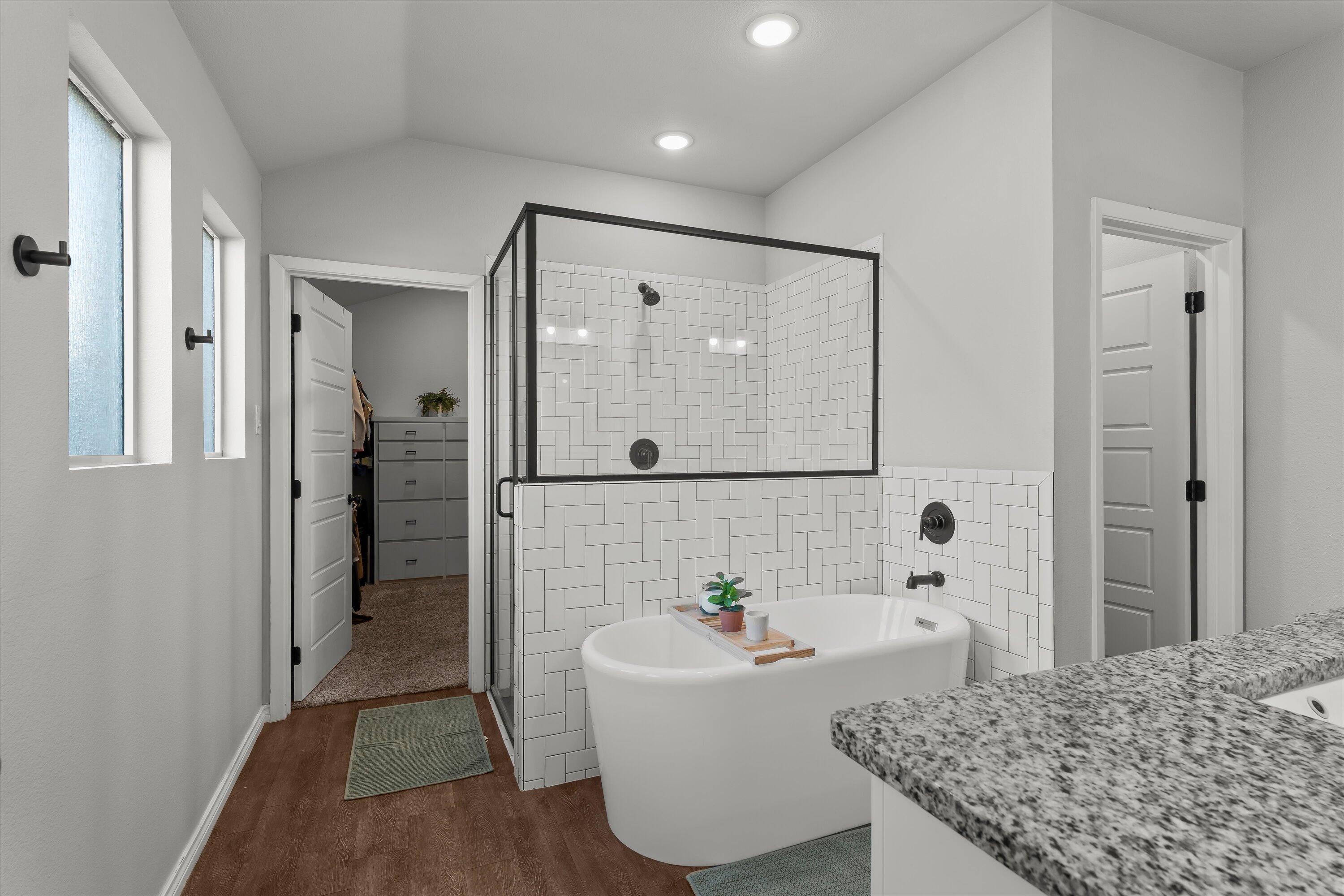 3438 125th Street Lubbock, TX 79423 - Photo 17 of 34 a bathroom with a granite countertop sink a mirror and shower