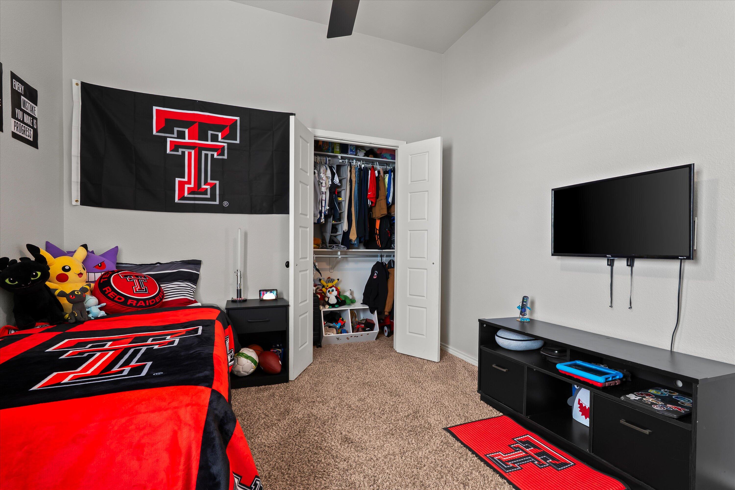 3438 125th Street Lubbock, TX 79423 - Photo 21 of 34 a living room with furniture and a flat screen tv