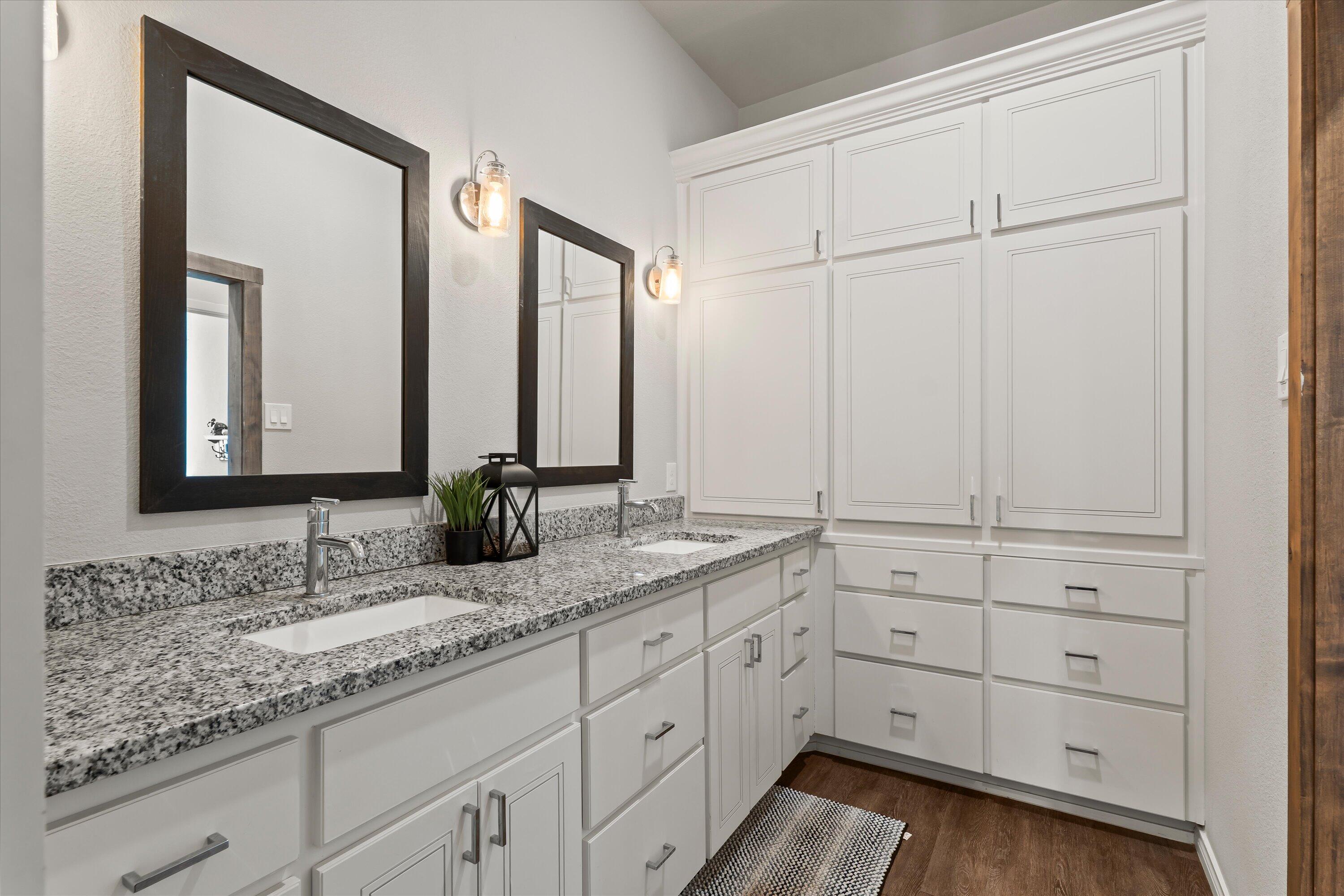 3438 125th Street Lubbock, TX 79423 - Photo 22 of 34 a bathroom with a double vanity sink and mirror