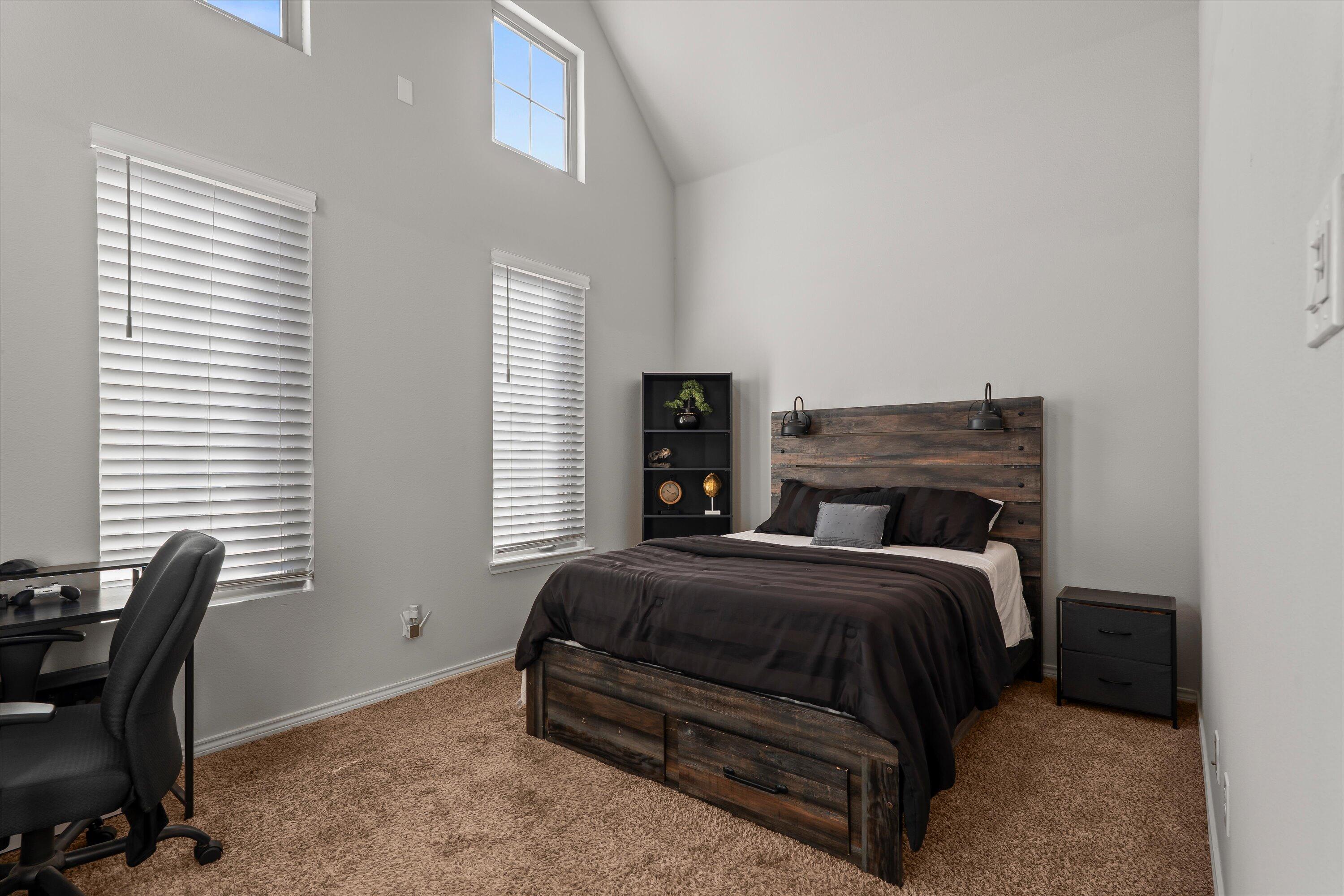 3438 125th Street Lubbock, TX 79423 - Photo 25 of 34 a bedroom with a bed chair and a window