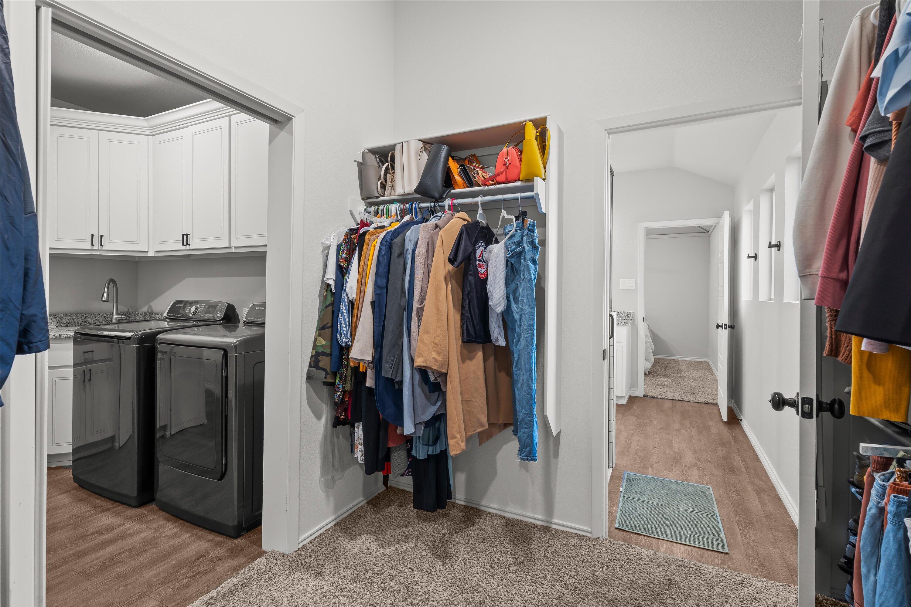 3438 125th Street Lubbock, TX 79423 - Photo 26 of 34 a view of walk in closet with clothes and shoes