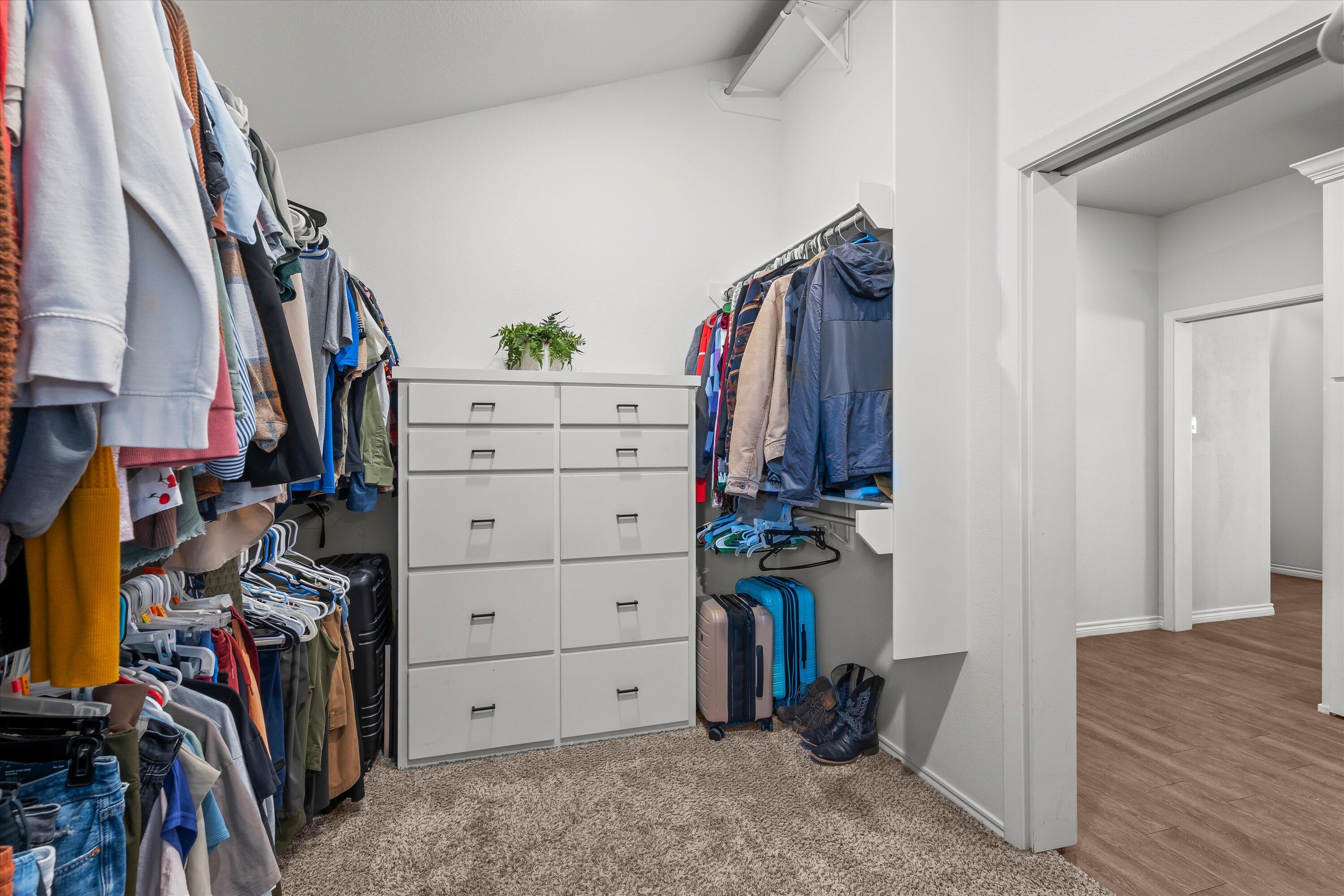 3438 125th Street Lubbock, TX 79423 - Photo 27 of 34 a view of walk in closet with clothes