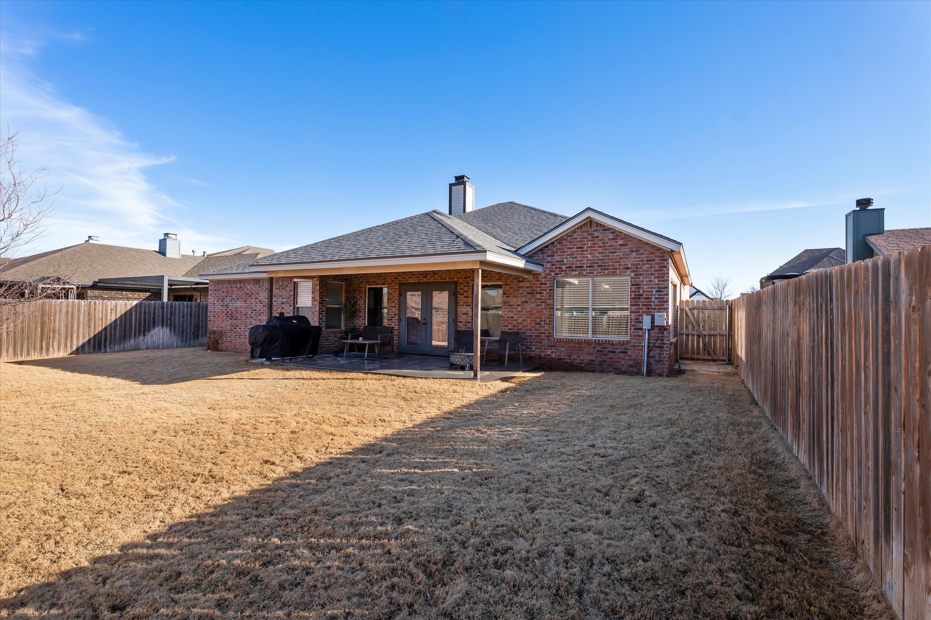 3438 125th Street Lubbock, TX 79423 - Photo 32 of 34 a front view of a house with a yard and garage