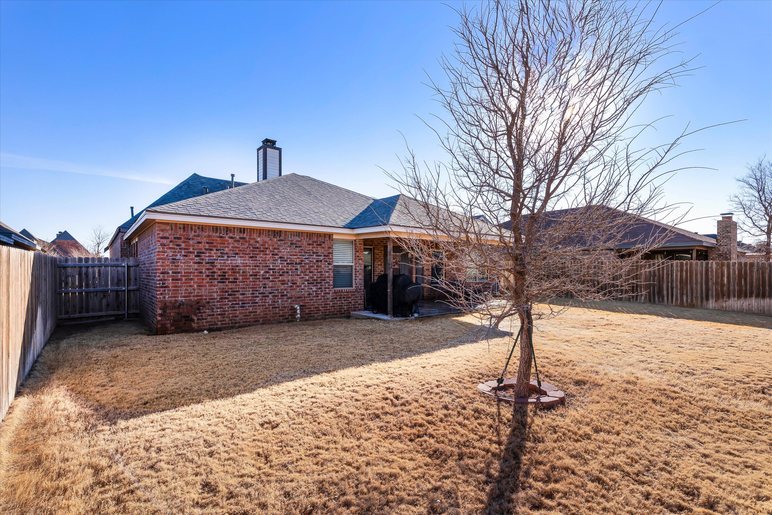3438 125th Street Lubbock, TX 79423 - Photo 34 of 34 a front view of a house with a yard covered in snow