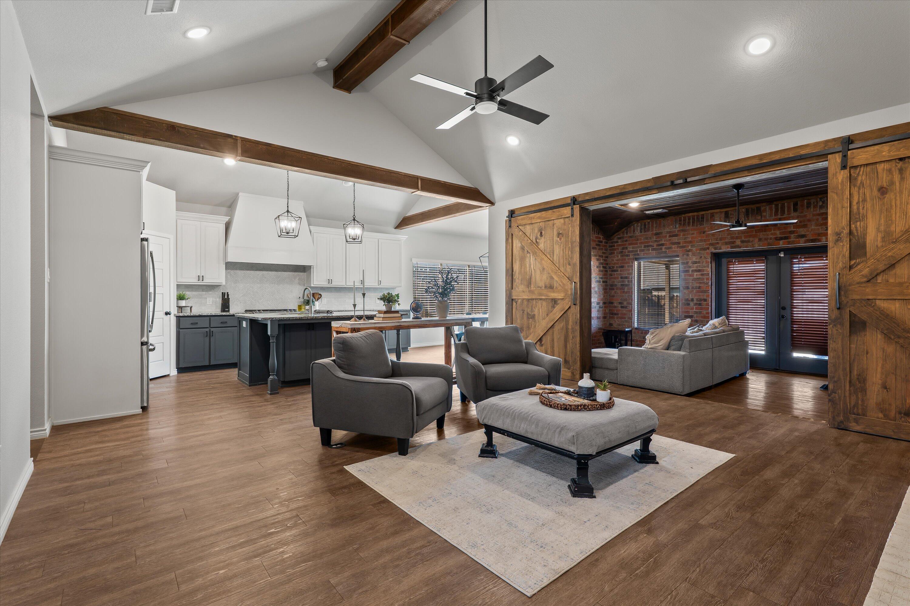 3438 125th Street Lubbock, TX 79423 - Photo 5 of 34 a living room with furniture kitchen and a chandelier