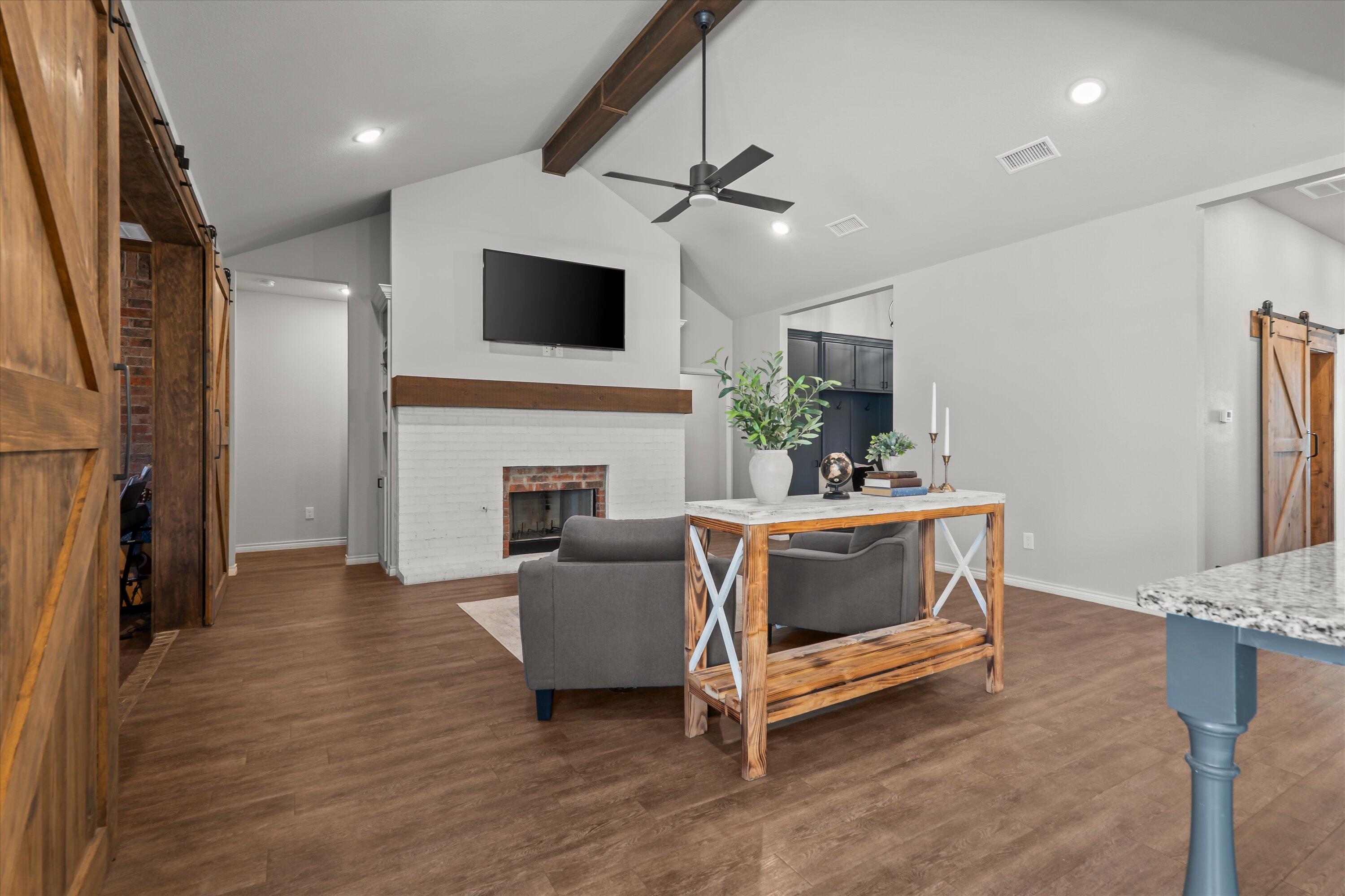 3438 125th Street Lubbock, TX 79423 - Photo 9 of 34 a living room with furniture and a fireplace