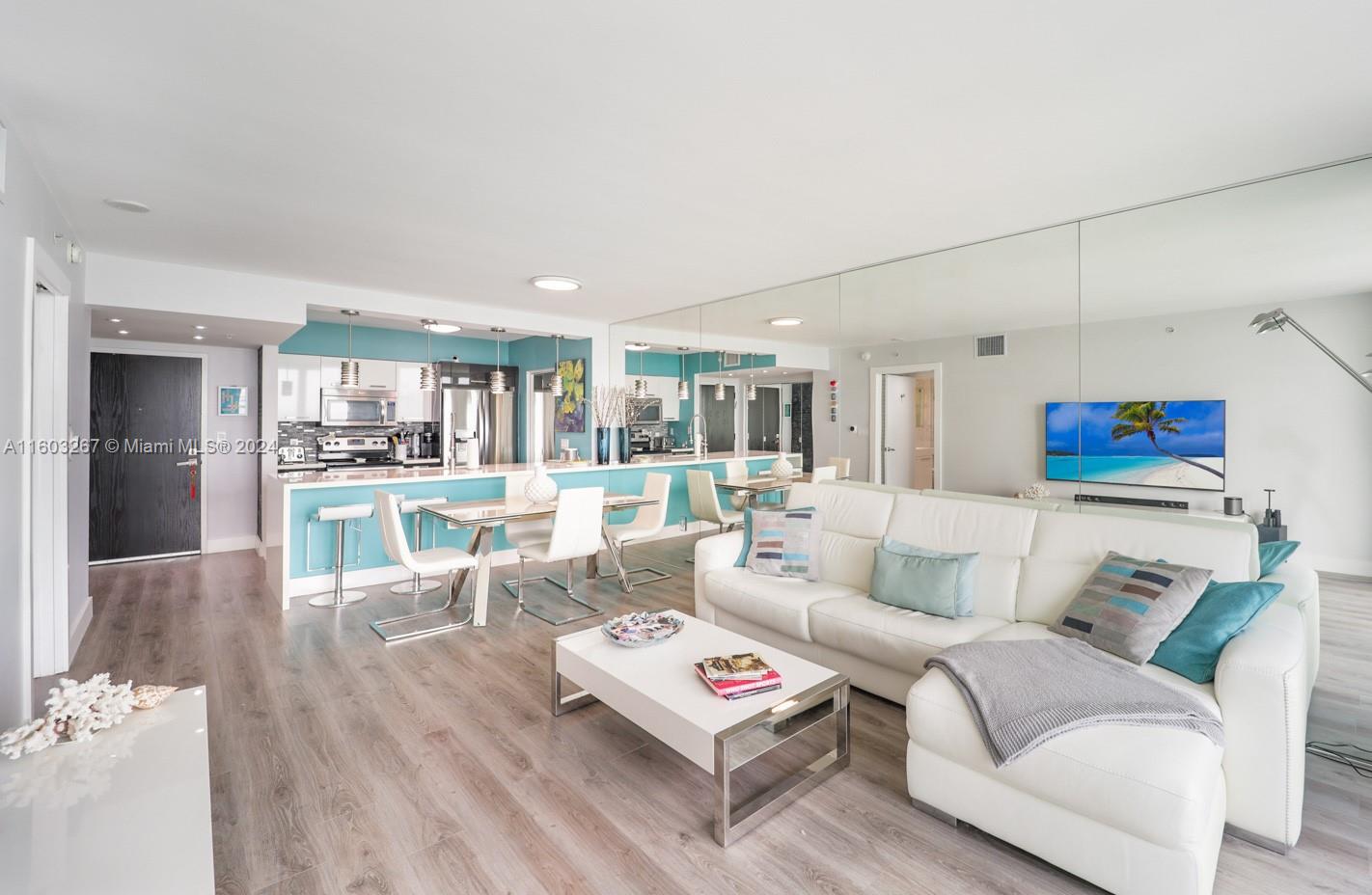 90 Alton Road, Unit 2806 Miami Beach, FL 33139 - Photo 11 of 36 a living room with furniture and a wooden floor